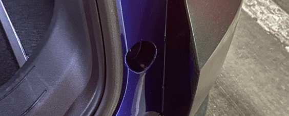 A close up of the original color of the car on the inside of the trunk without the car wrap