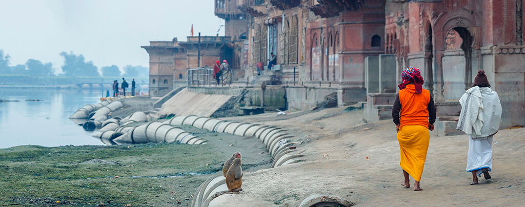 Vrindavan India January 2020: Pilgrims on the river near the temple. Krishna Temple at the Keshi Ghat on Yamuna river